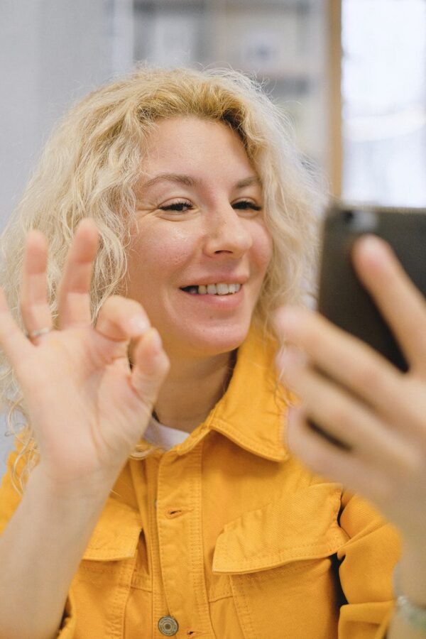 cheerful woman having video call on smartphone